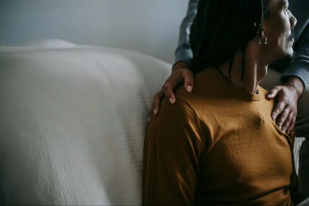 A woman holding the shoulder of a man