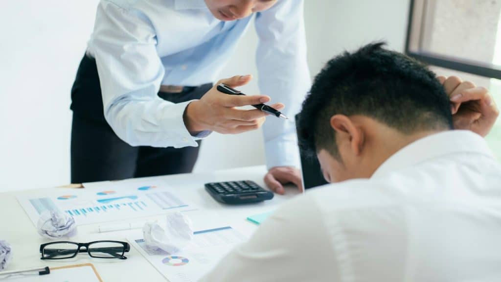 A man blaming his colleague about something