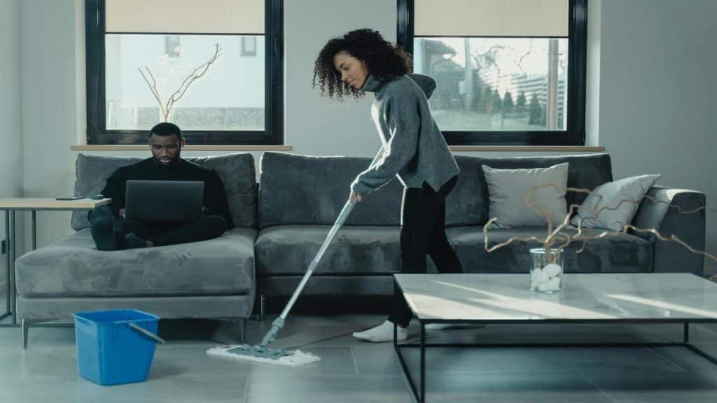 A couple doing their own thing in the living room