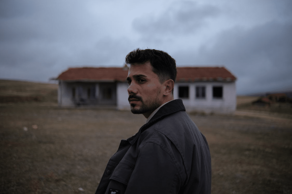 Pensive Man Outdoors Near Abandoned House