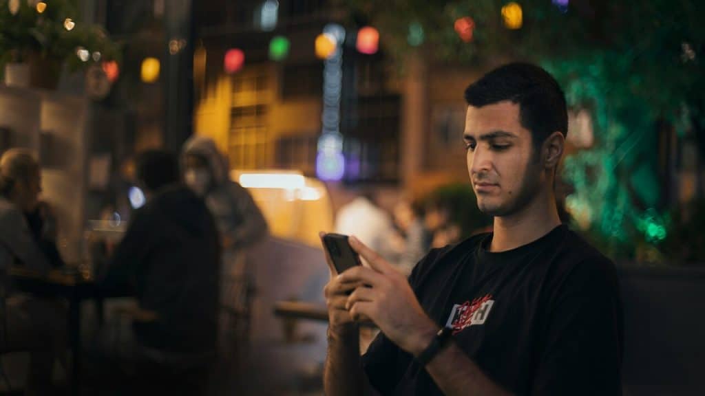 A man using his phone during a date