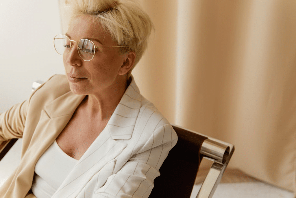 Close-Up Photo of a Businesswoman with Blond Hair Wearing Eyeglasses
