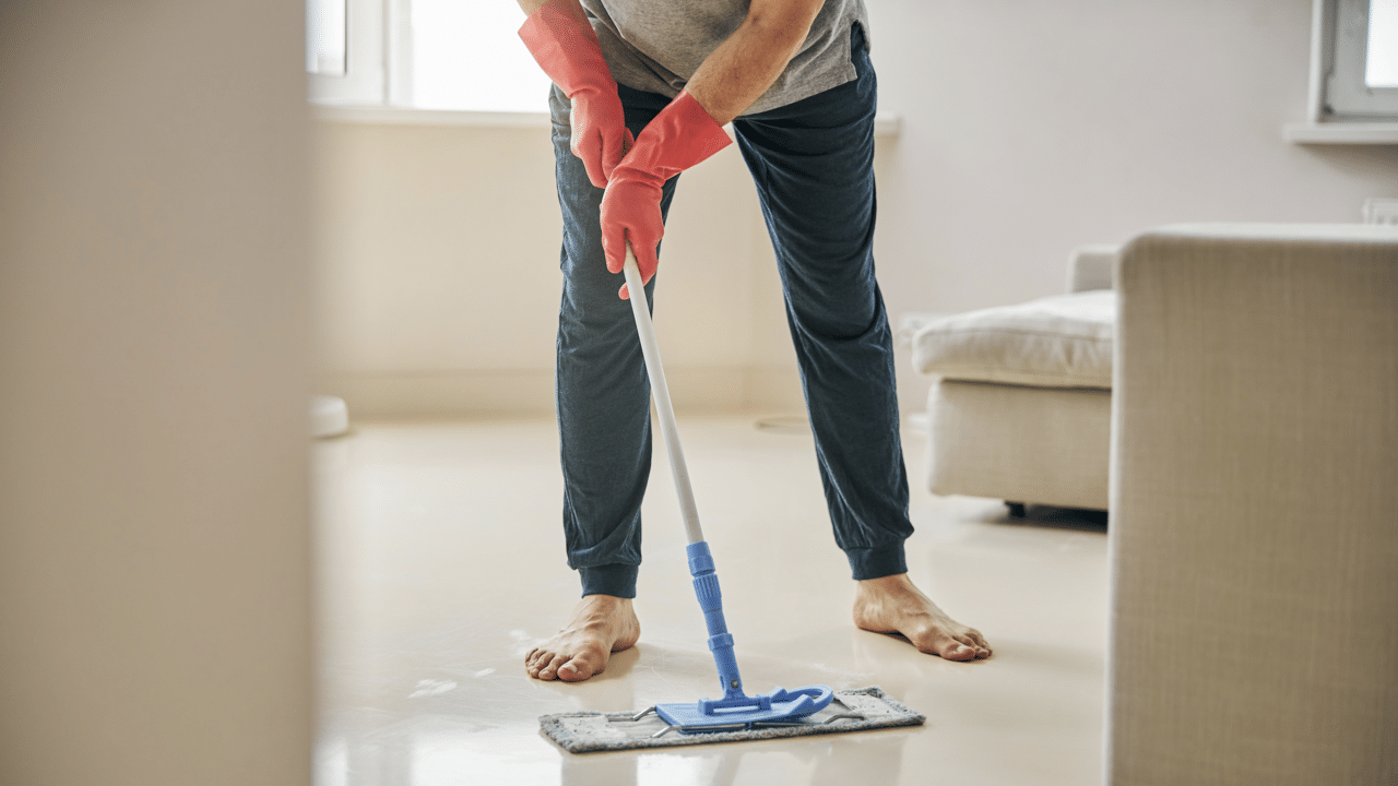 A man cleaning in the living room 