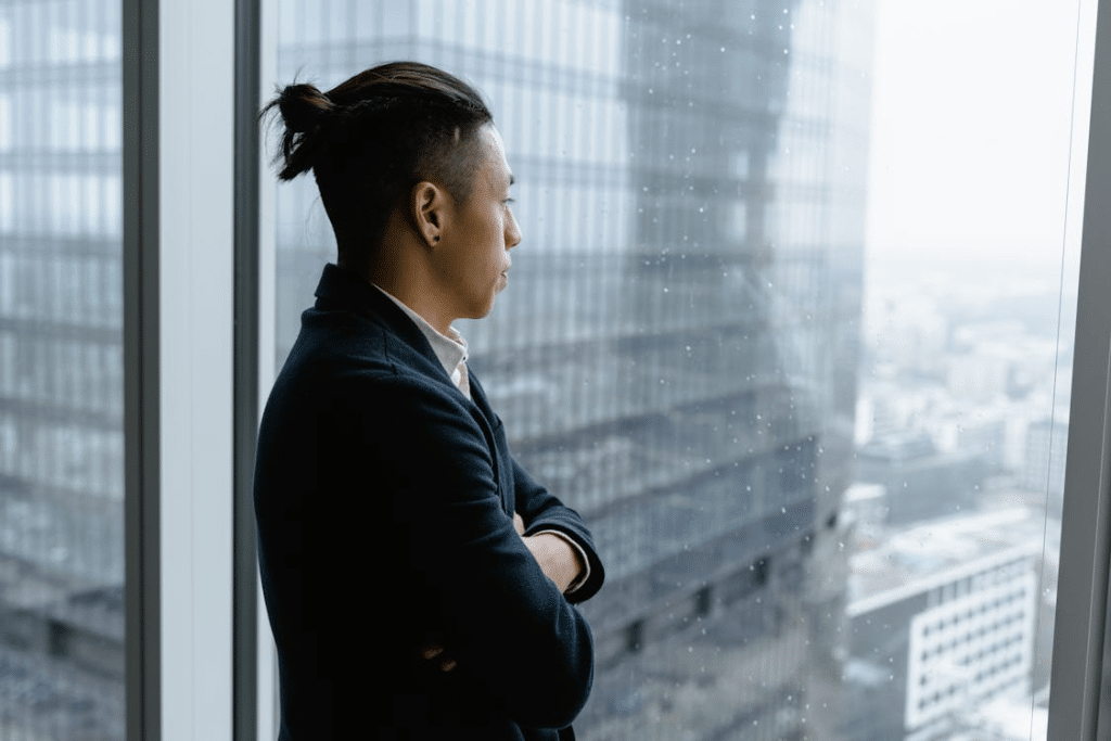 A man standing near the window