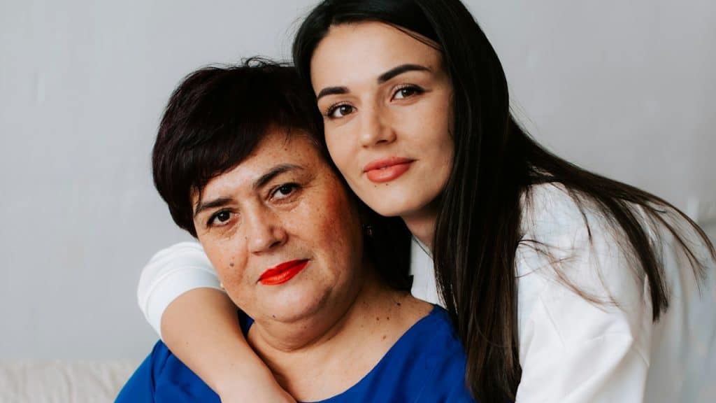 A woman hugging another woman.