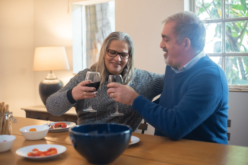 Elderly Man and Woman Holding Glass of Wine