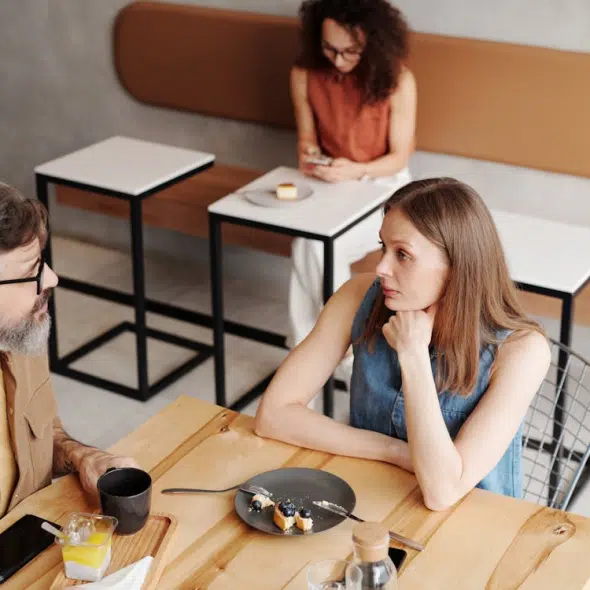 A man and a woman are sitting at the table