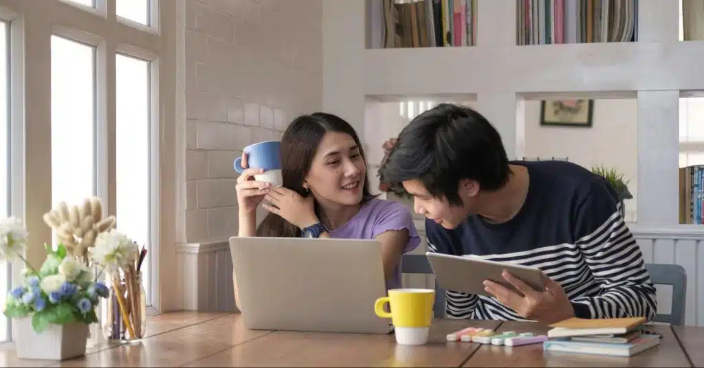 A man and woman busy with their gadgets