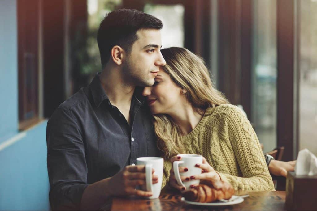 A woman leaning on a man’s shoulder 
