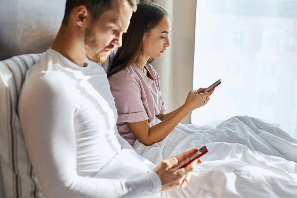 A man and woman using a phone