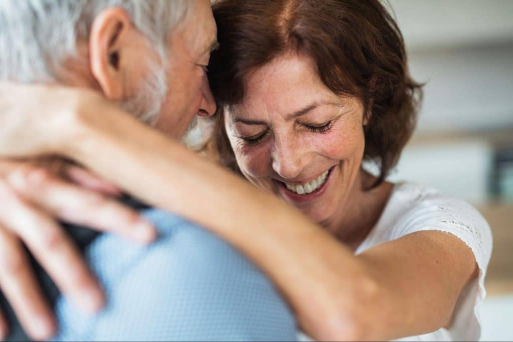 A man and woman hugging each other