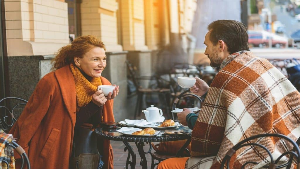 A couple talking at an outdoor cafe