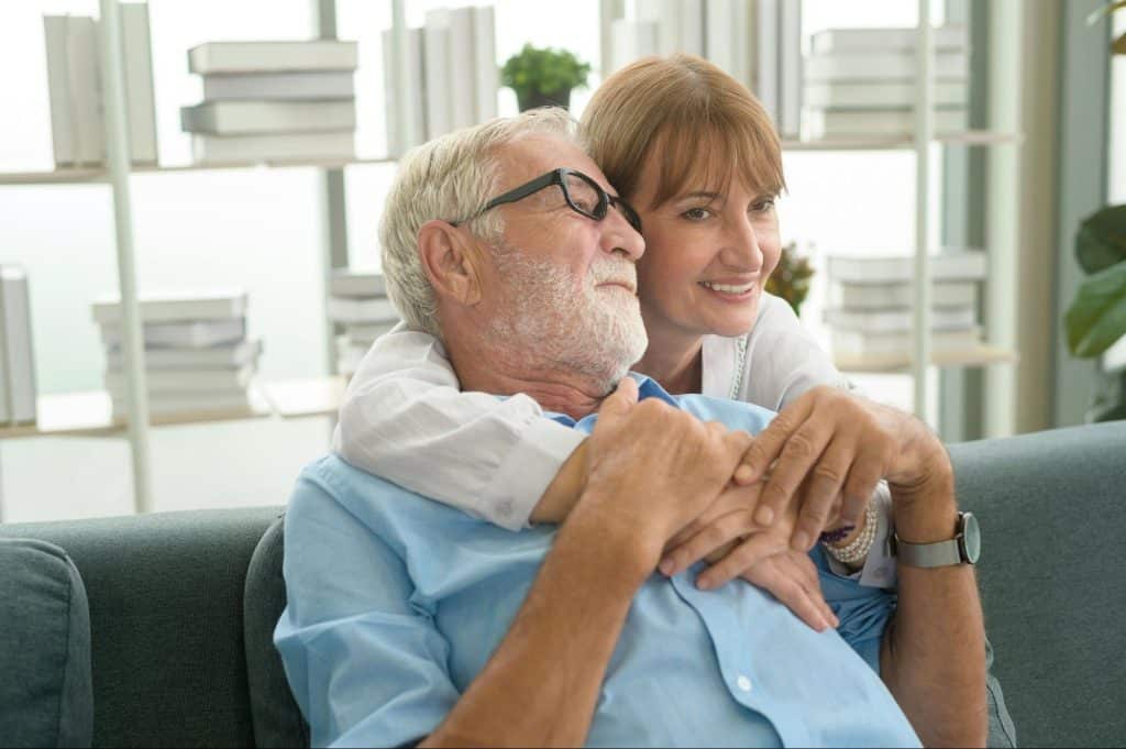A woman hugging a man