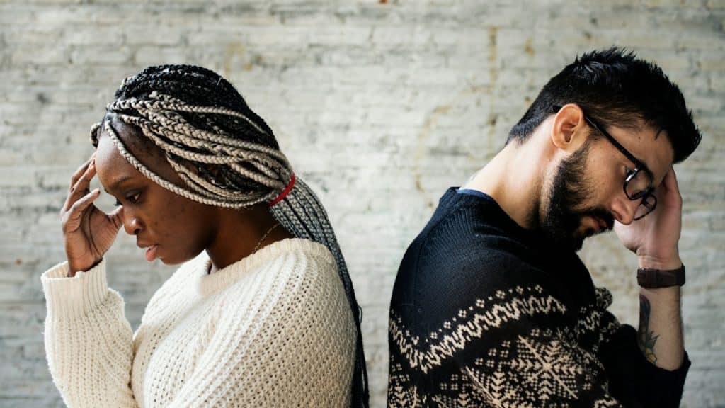 A couple looking away from each other.