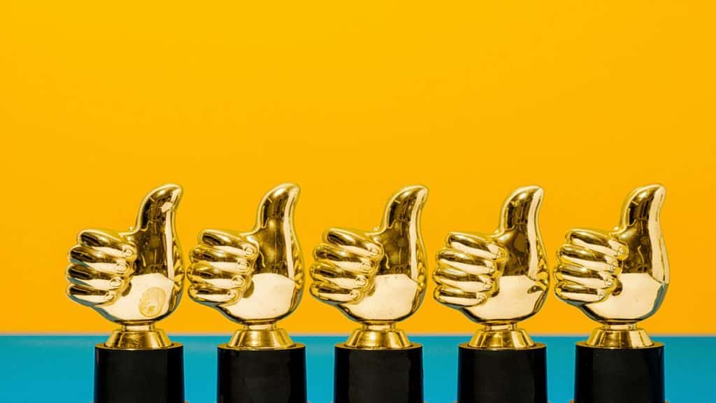 A photo of thumbs up trophies