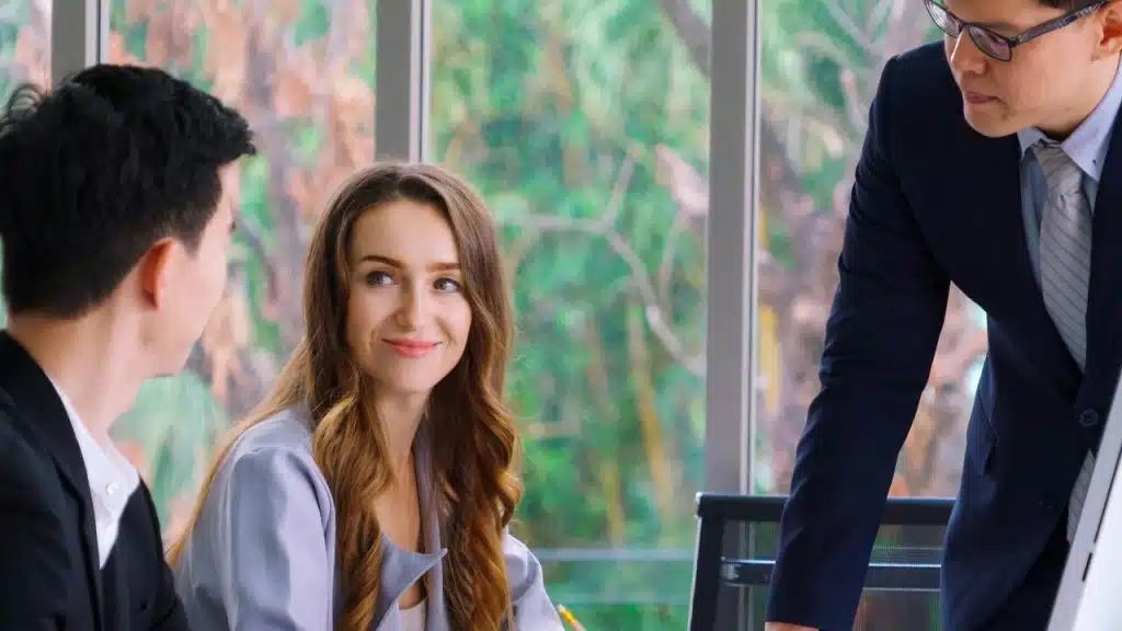 A woman looking at her colleague and smiling