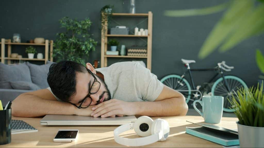 A man sleeping on his desk