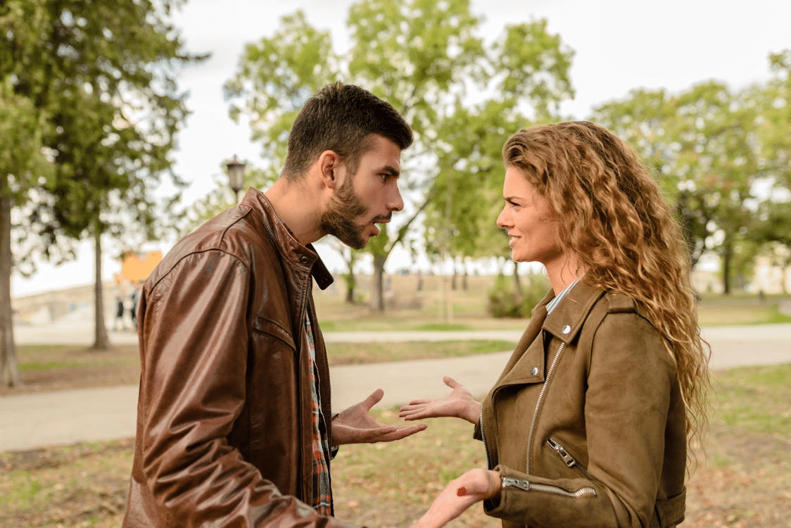 Man and woman wearing brown leather jackets