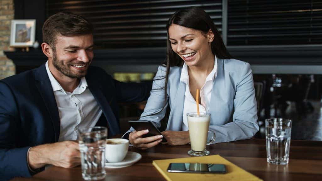 Colleagues laughing at a coffee shop
