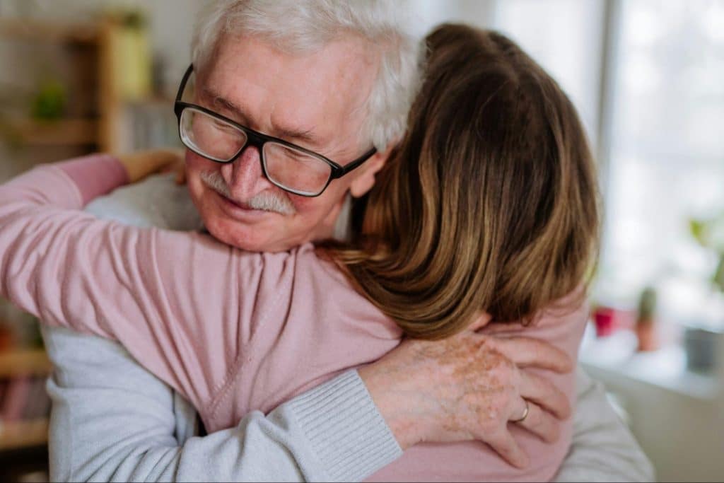 A man and woman hugging for forgiveness