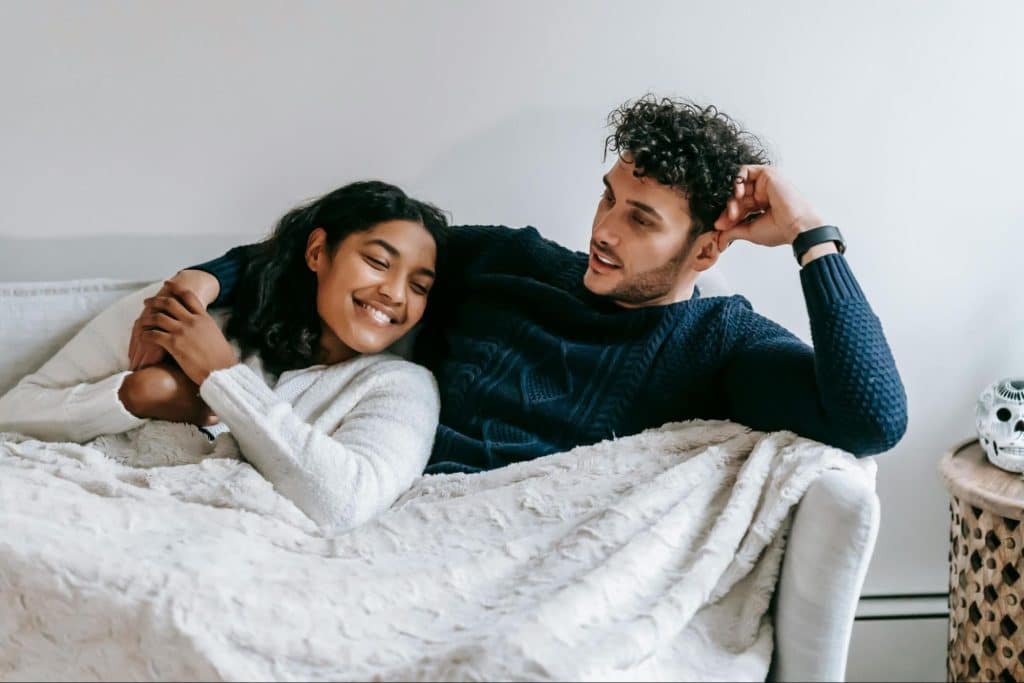 A man and woman resting at the sofa