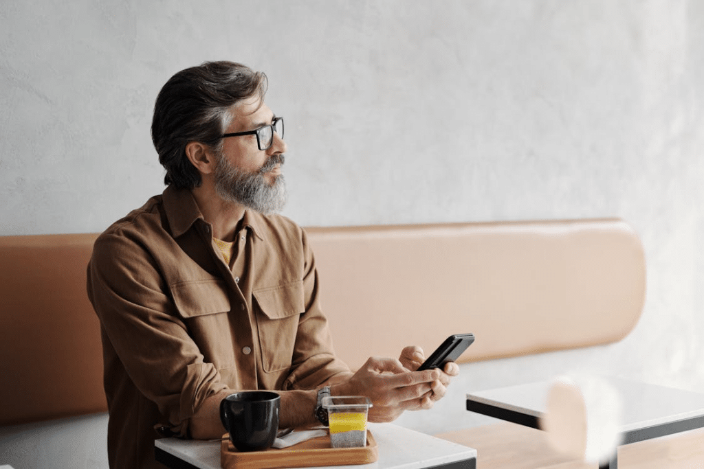 Photo of a Bearded Man Holding Cellphone