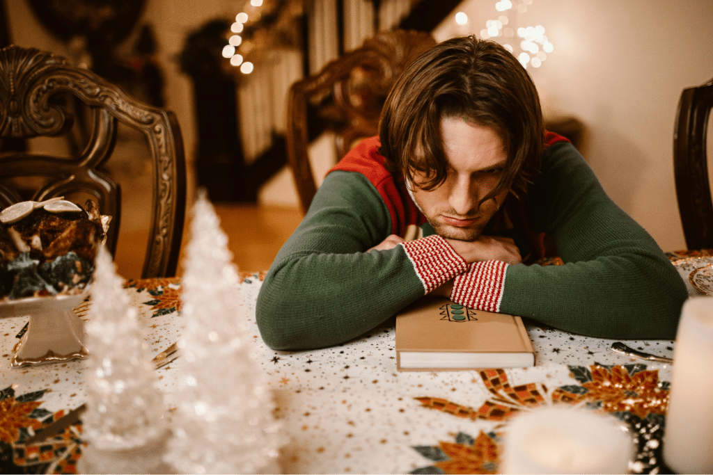 A Man in Green Sweater Lying on the Table