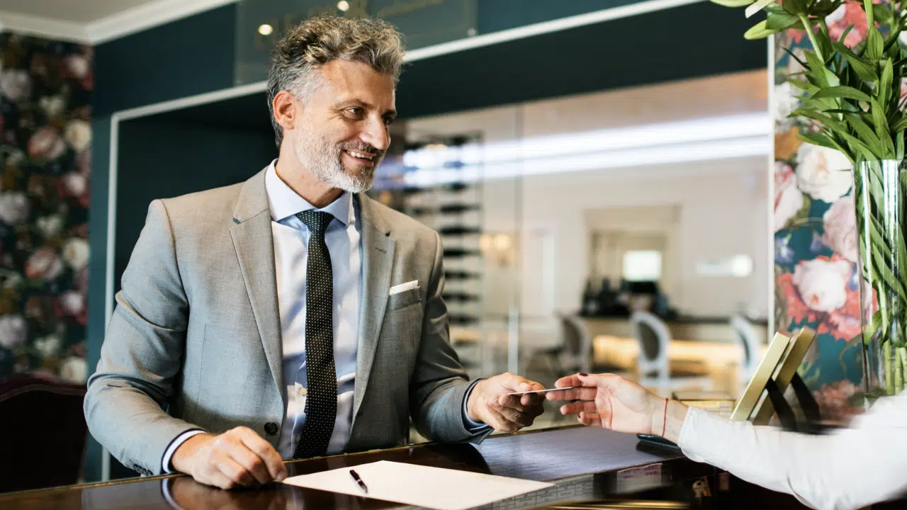 A man paying at the reception 