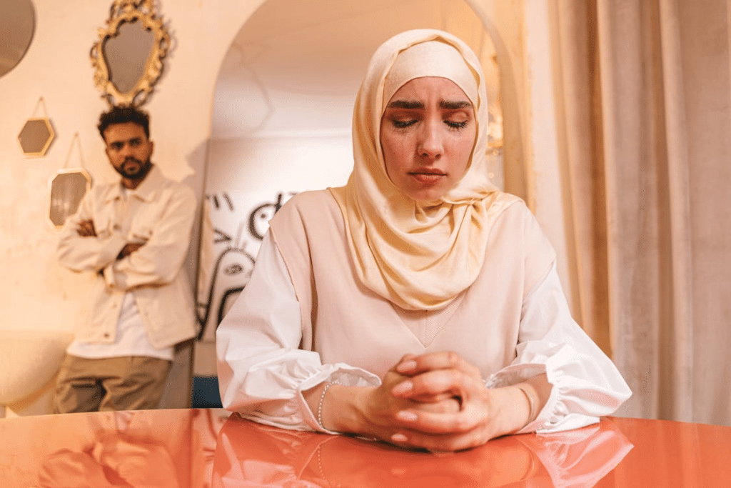 A woman crying with her husband at her back