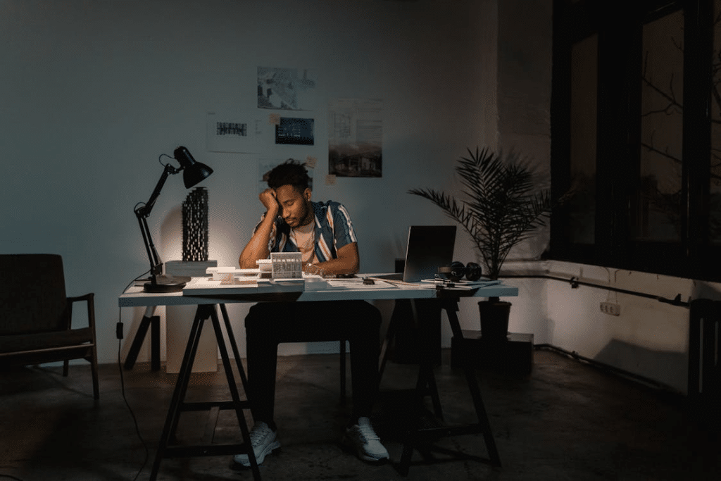 Man sitting and leaning to his desk