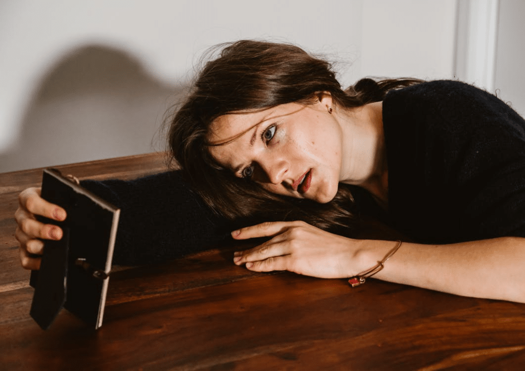 A crying woman holding a frame