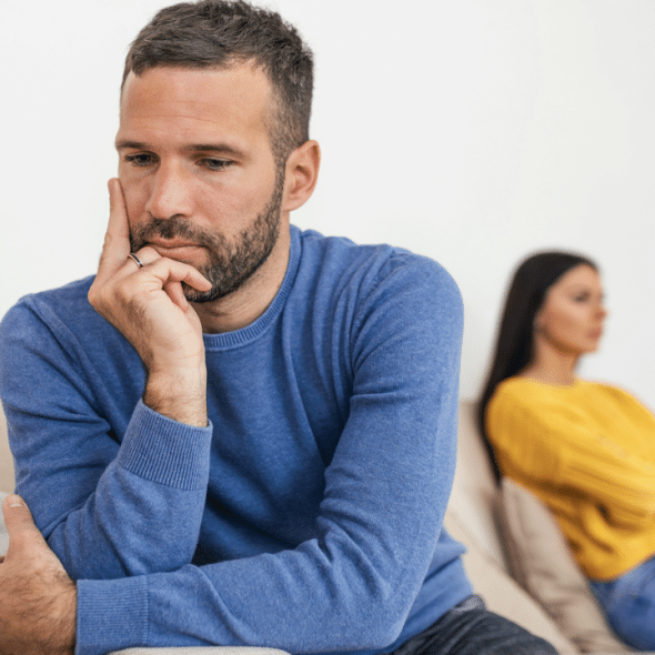 A man looking miserable at home