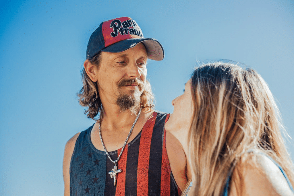 Man in Cap Looking at the Woman