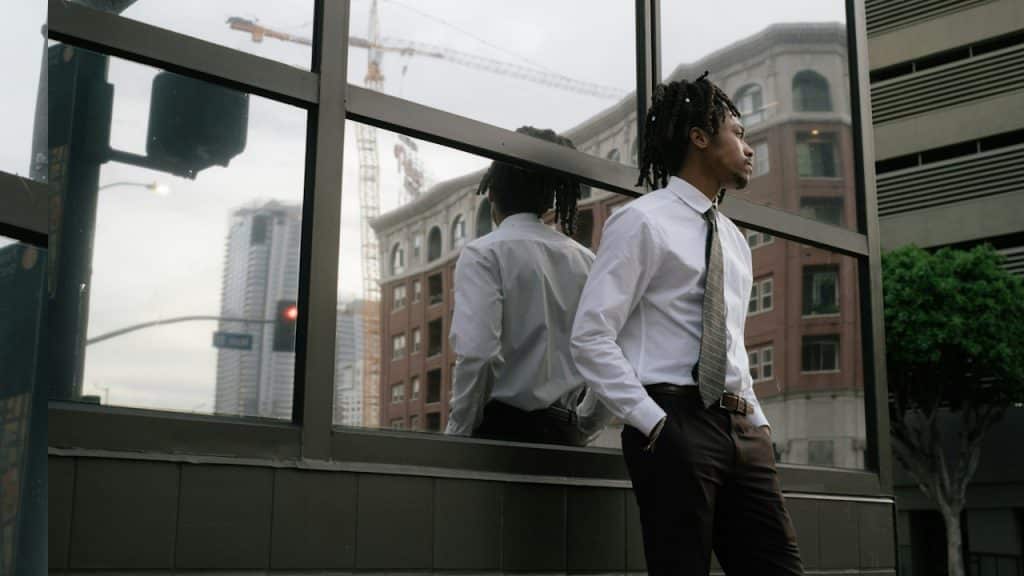 A man standing in front of a window.