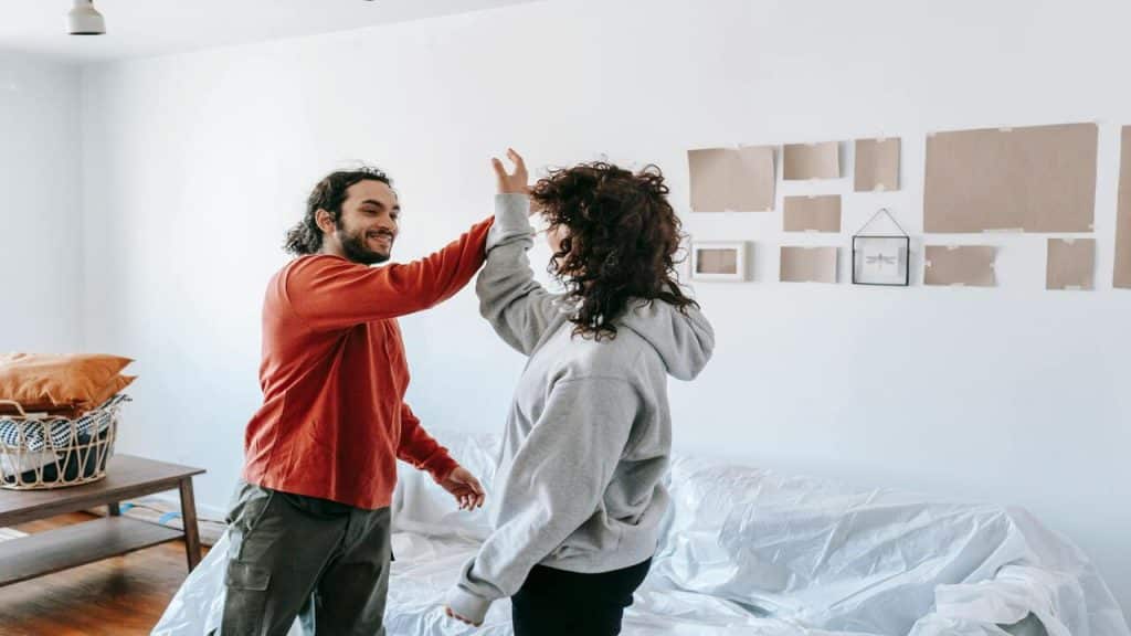 A couple high fiving at home