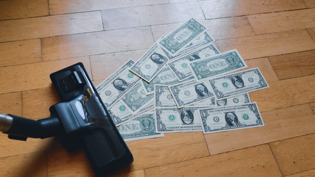 A pile of money spread on the floor.