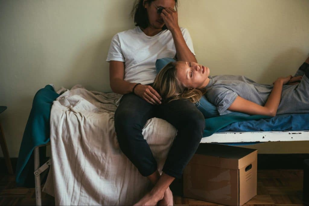 A woman resting on a man’s lap