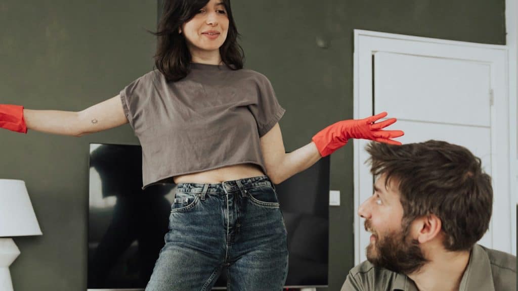 A woman criticizing her husband for sitting idle.