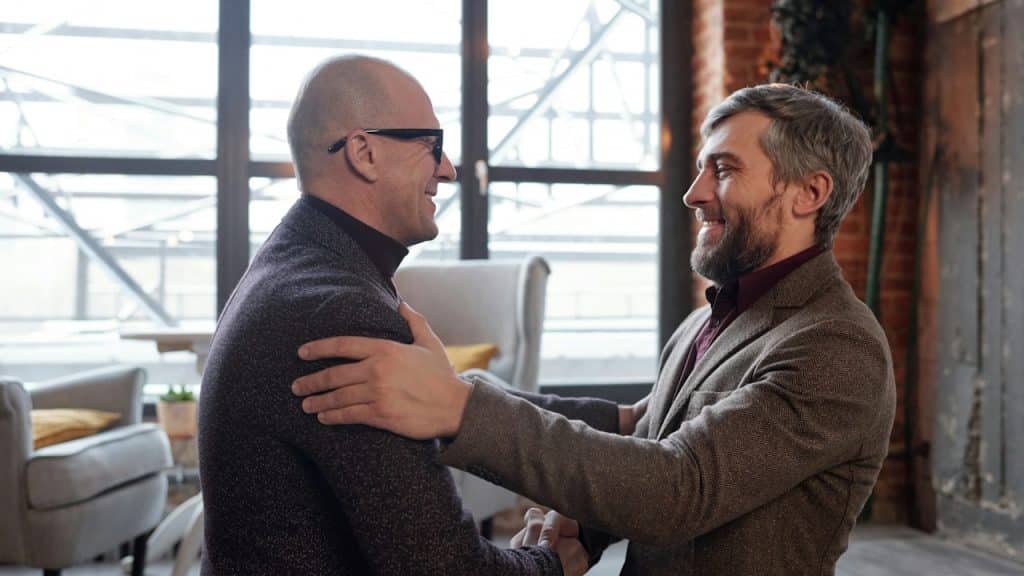 Two men shaking hands inside an office.