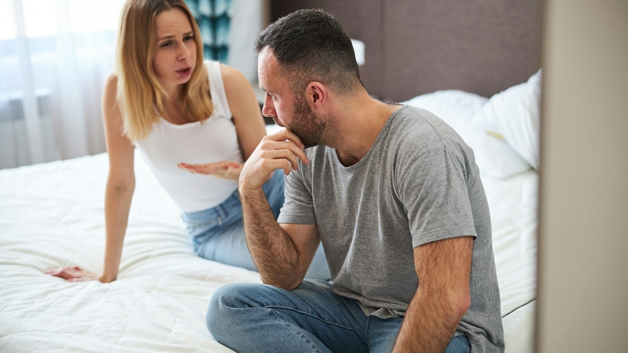 A displeased woman talking to her husband.