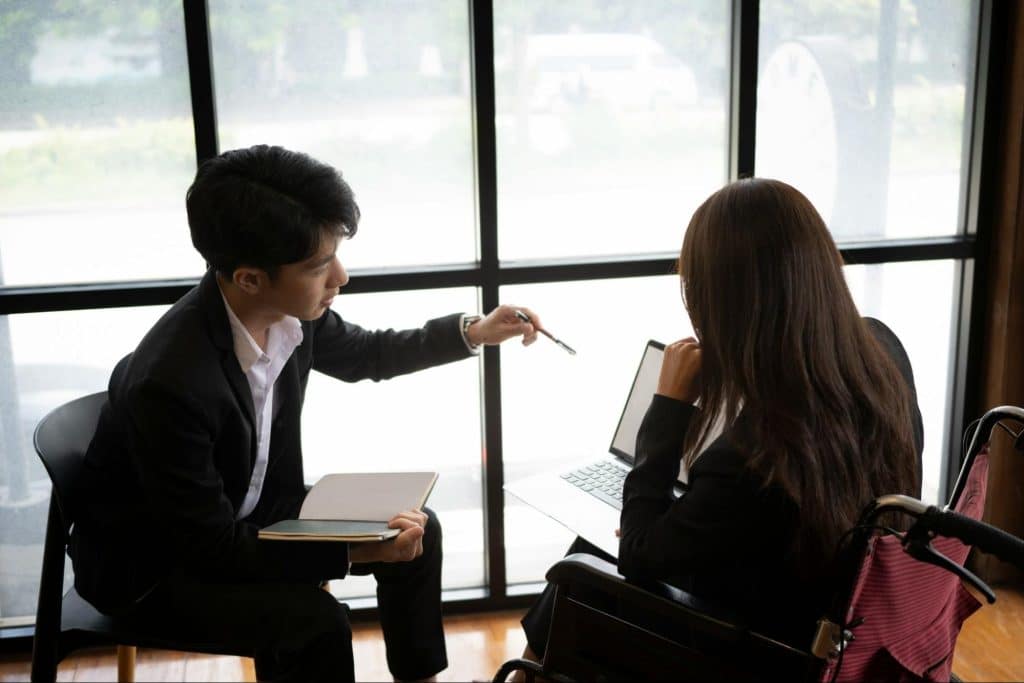 A man and woman talking about their work