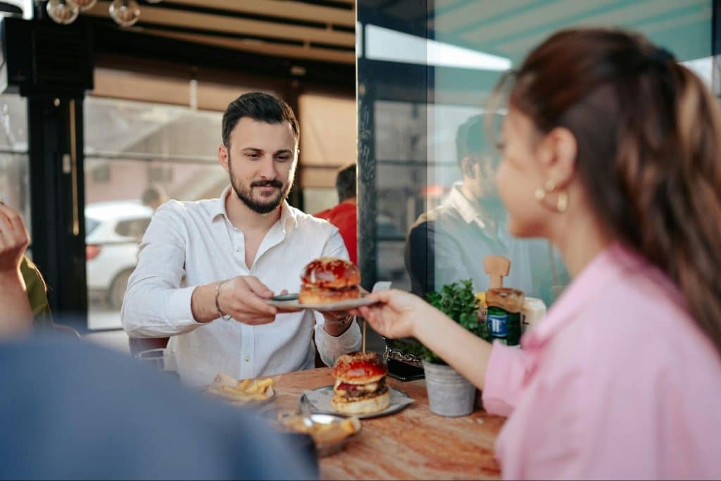 A woman giving a food to man