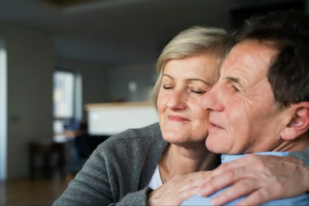A woman hugging a man