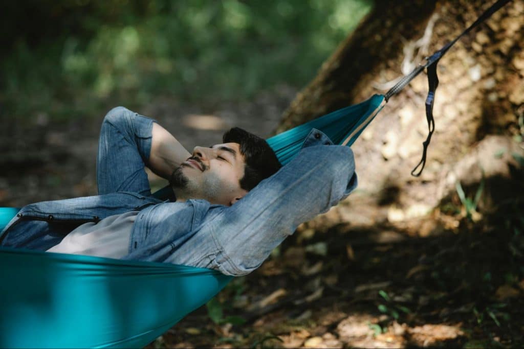A man laying at the hammock
