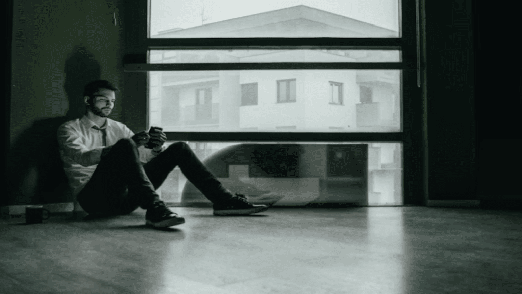 A man looking sad while scrolling