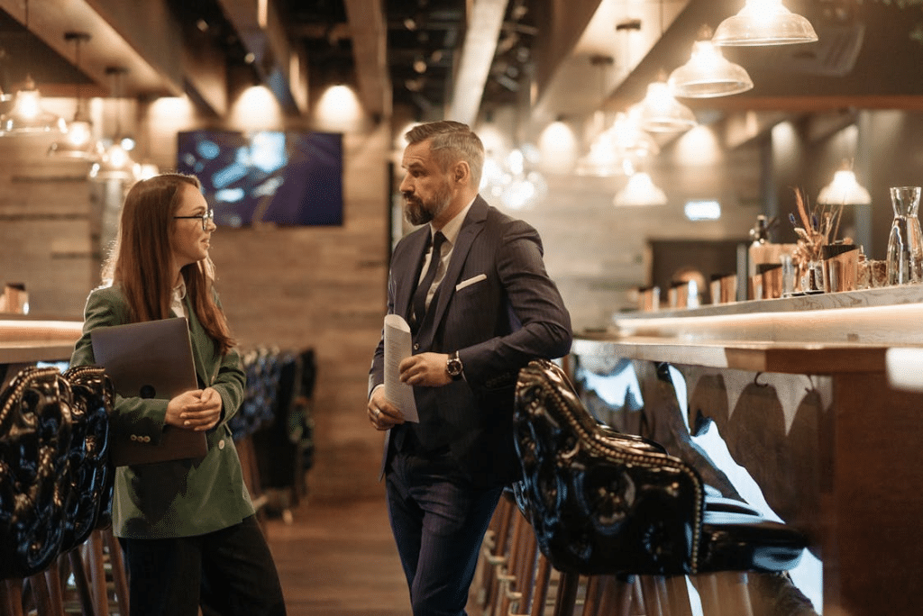 A man and a woman talking at a bar