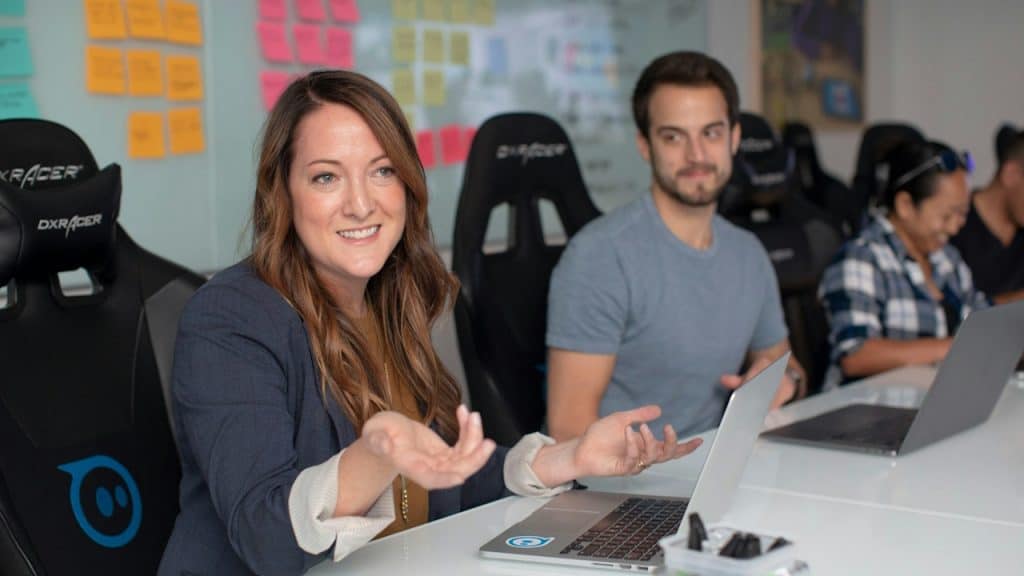 A woman giving a presentation to her team.