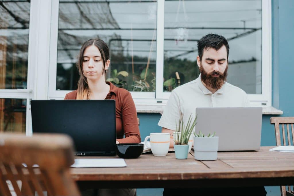 A man and woman using a laptop