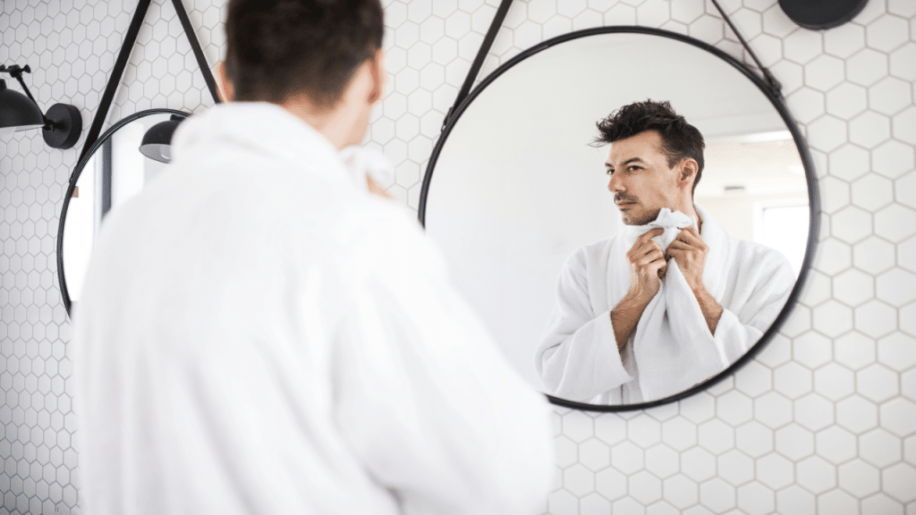 A man looking at himself in the mirror