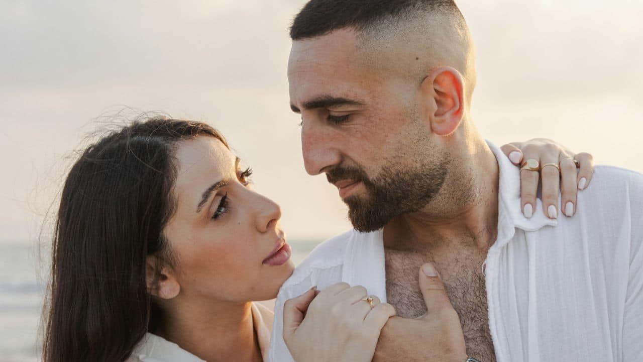 Close-up of a couple outdoors, the woman gazing up at the man.